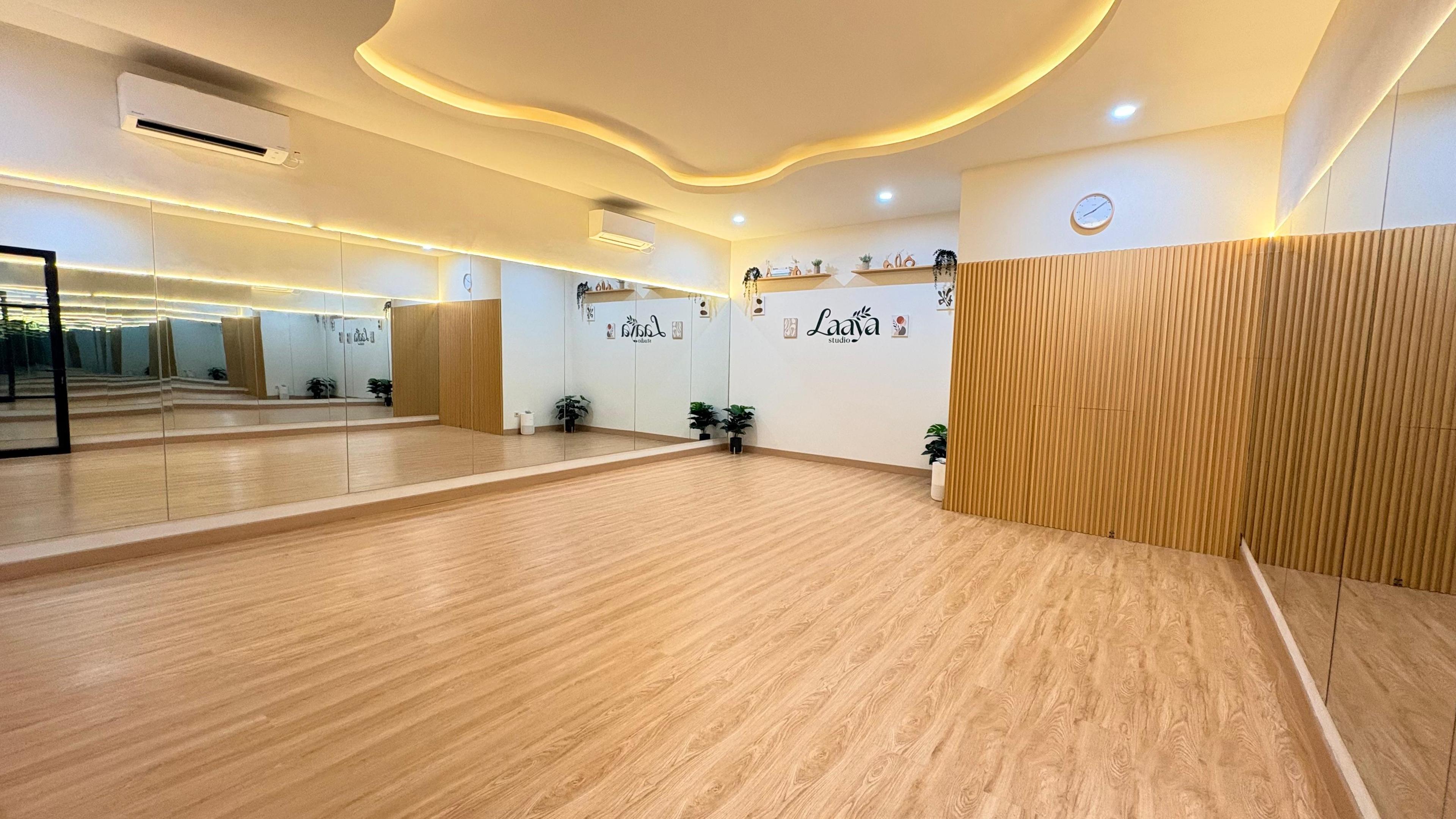 Main studio room with mirrors and wooden floor